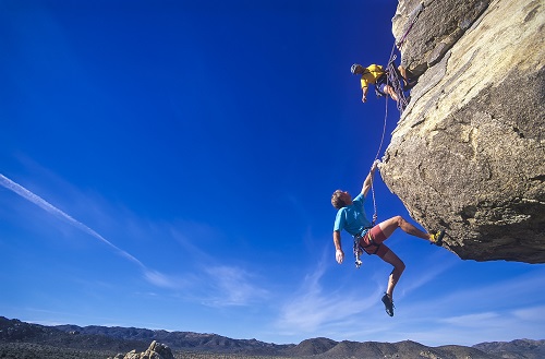 man-hanging-from-cliff